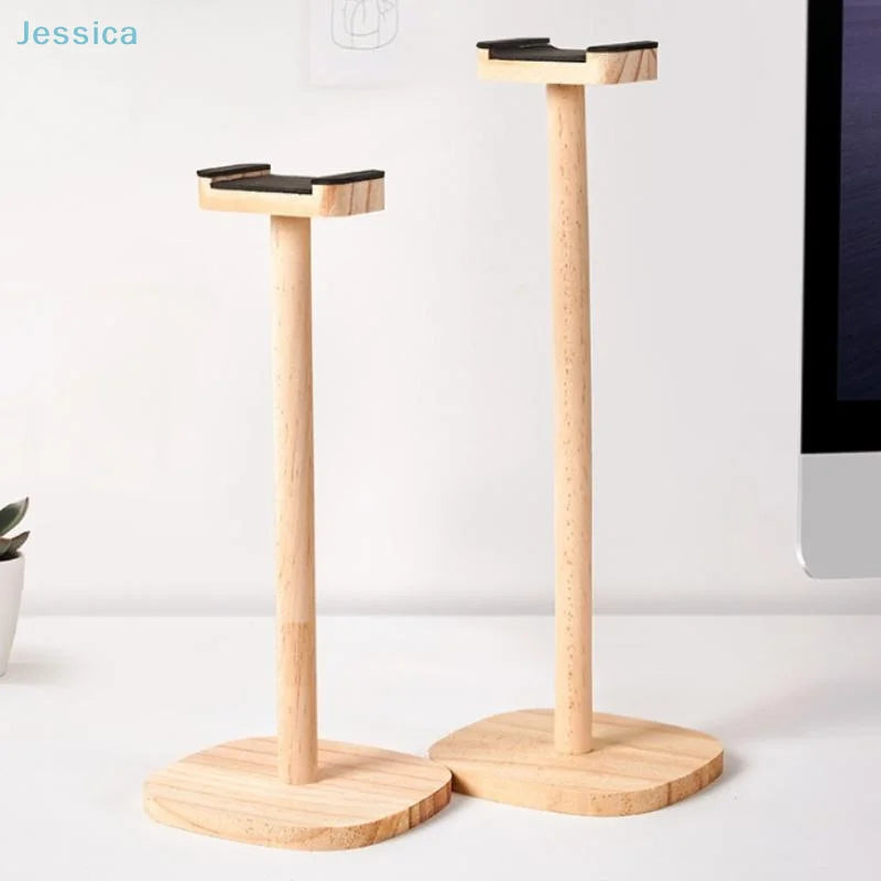 Two light-colored wooden wood headphone stands with black rubberized tops and stable circular bases for gaming over-ear headphones