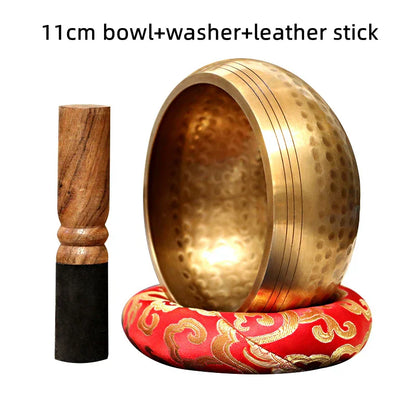 Golden 11cm tibetan buddha sound bowl with hammered texture resting on red and gold cushion for sound bowl yoga