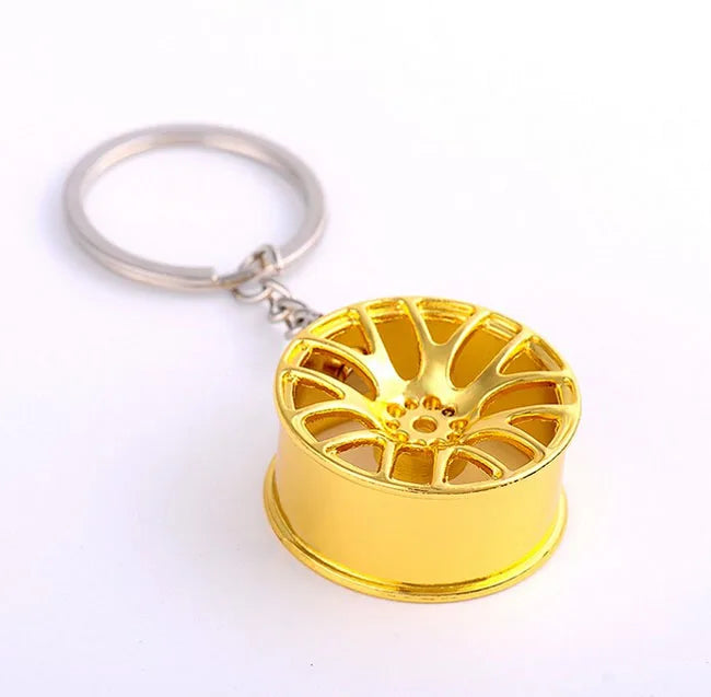 Golden metallic 3d miniature car wheel rim keychain with intricate spoke design hub key chain for car key ring gift