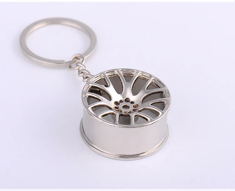 Silver metallic miniature car wheel rim keychain with detailed spoke design metal hub key chain and car key ring gift