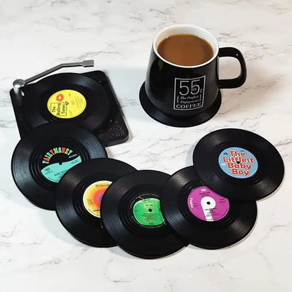 Set of six black retro vinyl record cup coasters with colorful labels featuring heat resistant music designs for mugs