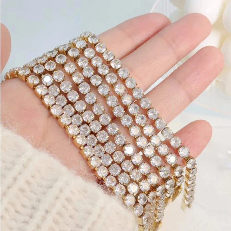 A multi-strand gold-toned tennis bracelet rose with clear rhinestones and silver hip hop zirconia bracelet wedding design