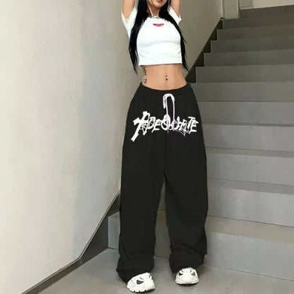 Black high waist wide leg sweatpants with white graffiti style absolute lettering for hip hop jazz dance use
