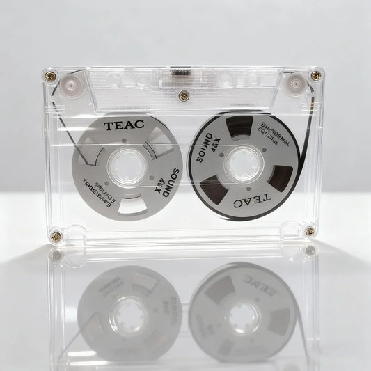 Clear plastic cassette tape case with teac branded silver and black audio cassette metal reels for tape hifi music recording