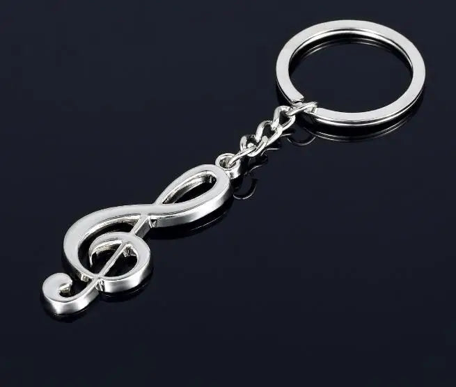 Silver metallic classic guitar keychain featuring a polished treble clef pendant with chain and ring musical instruments design
