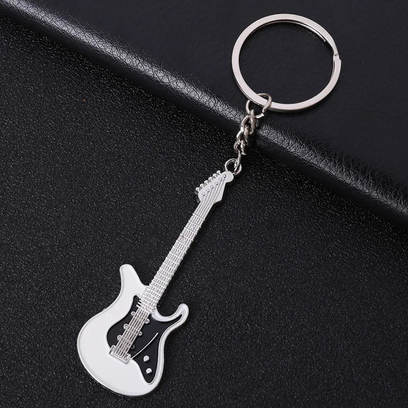 Silver electric guitar keychain with black pickguard and white metallic body for classic guitar keychain car use