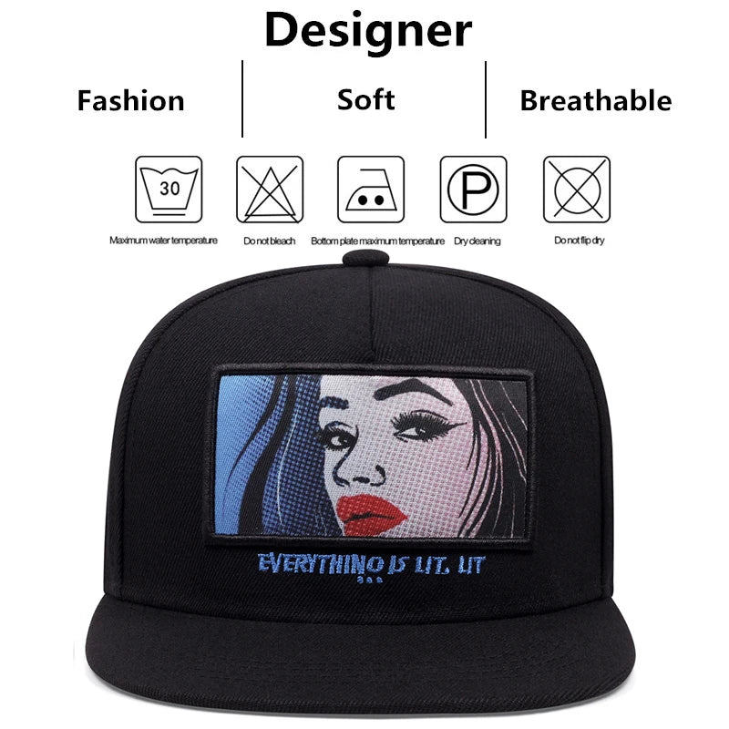 Black snapback cap with a black red label rectangular patch featuring a pop-art woman and embroidered text