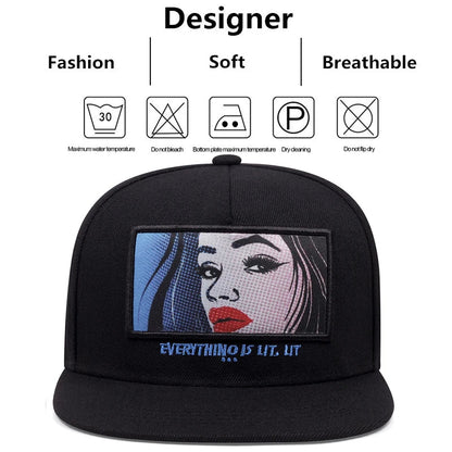 Black snapback cap with a black red label rectangular patch featuring a pop-art woman and embroidered text