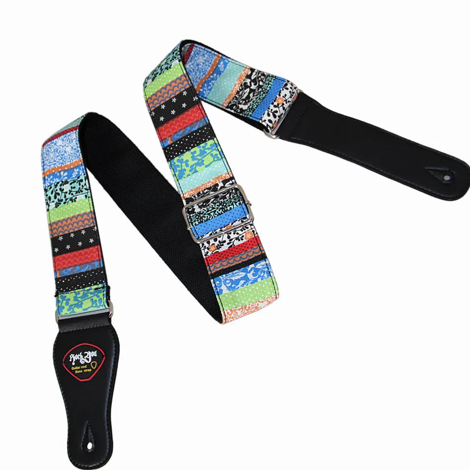 A vibrant patchwork cotton guitar strap with black leather ends adjustable for acoustic and bass guitar use with five star feedback