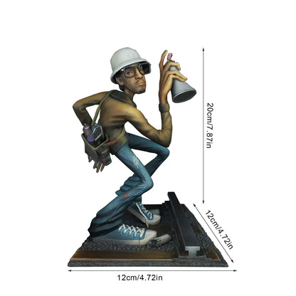 A detailed resin hiphop artist statue in break dance shape with a white hard hat and spray can on a textured base