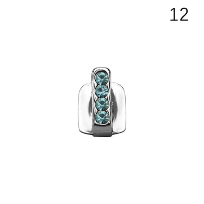 Silver-toned dental grills jewelry charm with four teal rhinestones in a sleek design for hip hop and cosplay use
