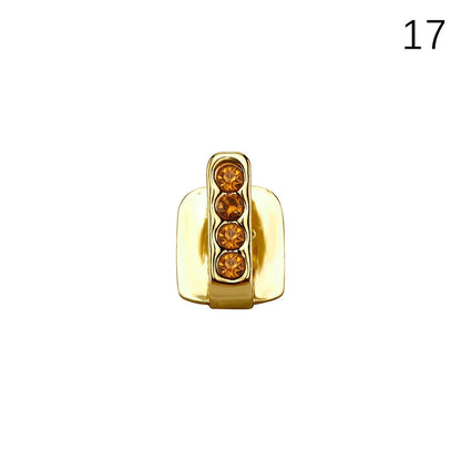 Gold-colored dental grills jewelry with four amber rhinestones in a vertical row for hip hop cosplay and casual wear