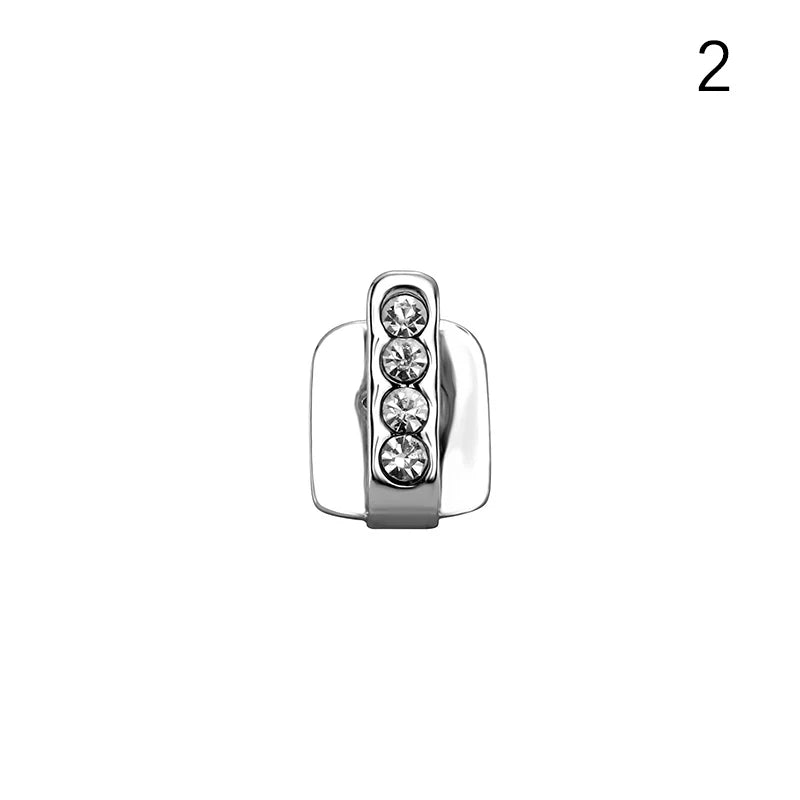 Silver-toned earring back with four clear crystals in a row shown as part of hip hop dental grills jewelry accessory