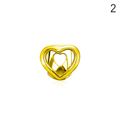 Gold-colored heart-shaped dental grill with hollow center and smooth reflective surface made of high-quality materials