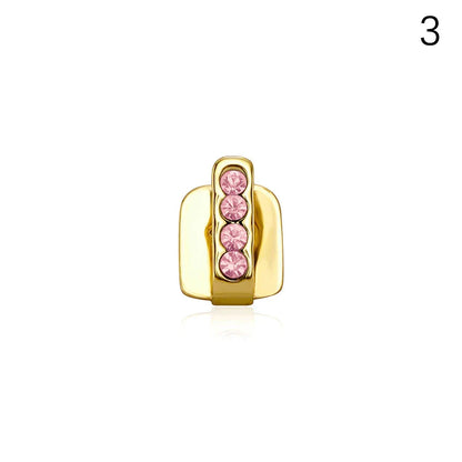 Gold-colored metal dental grills jewelry featuring four vertically aligned pink rhinestones made of high-quality materials