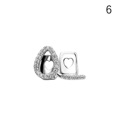 Silver heart-shaped earring studs with clear crystal pave setting complement new hip hop dental grills jewelry made of high-quality materials
