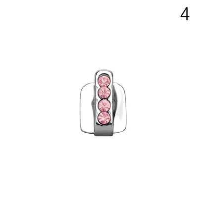 A sleek silver dental grill with four pink rhinestones in a minimalist design for men and women grills jewelry