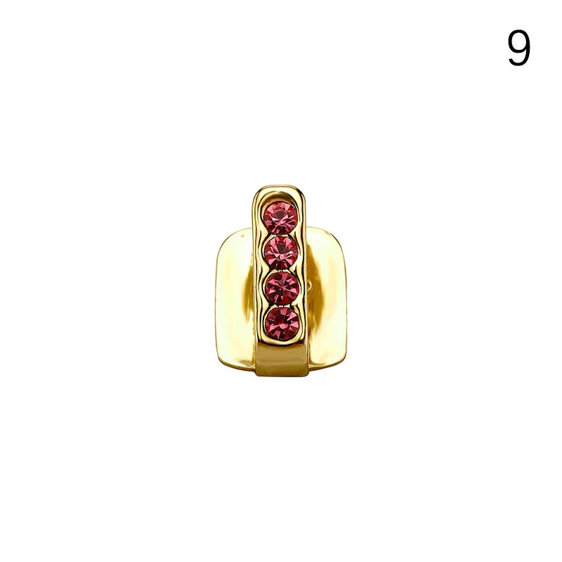 Gold-colored hollow double tooth dental grills jewelry with four embedded red gemstones for hip hop and cosplay use