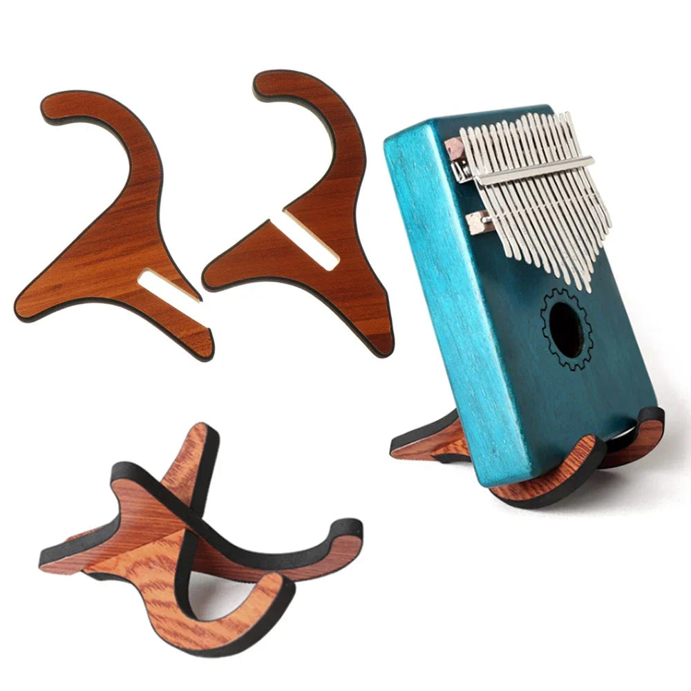 Teal kalimba with silver tines and gear-shaped sound hole displayed on a wooden foldable holder musical strings vertical ukulele stand