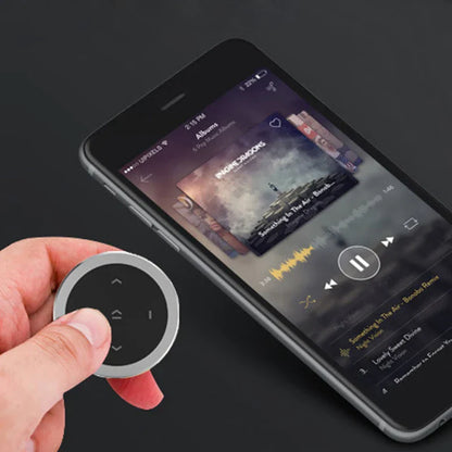Silver circular wireless bluetooth media remote with black buttons for phone bluetooth music playback and siri control