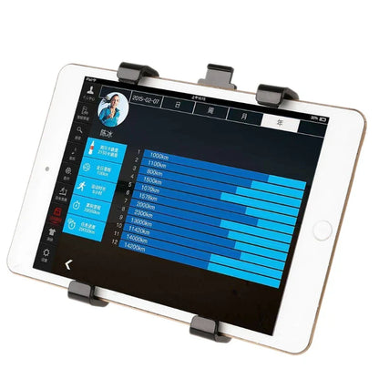 White tablet with black clip mount displaying fitness app on screen in a swivel stand bike gym handlebar mount