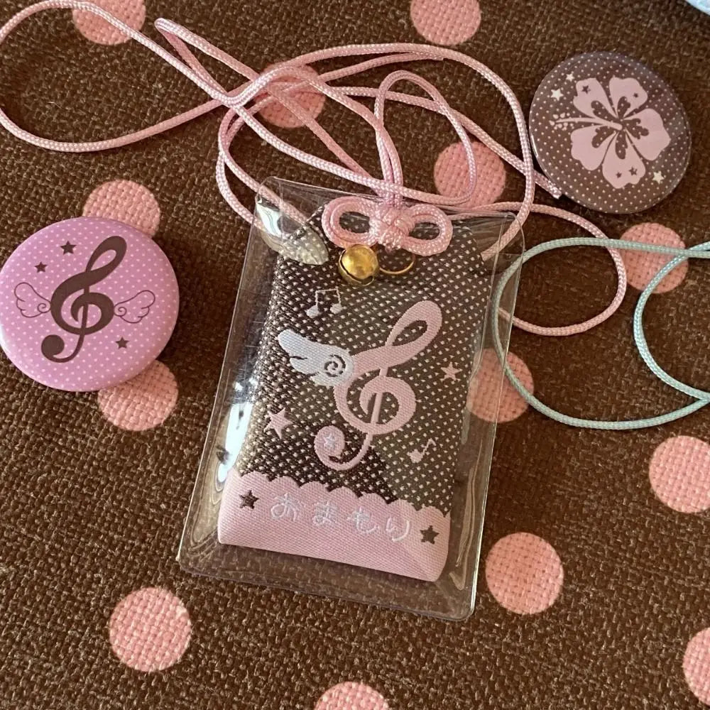 A clear plastic charm pouch with pink and black musical notes wings design diy embroidery blessings gift keyring key