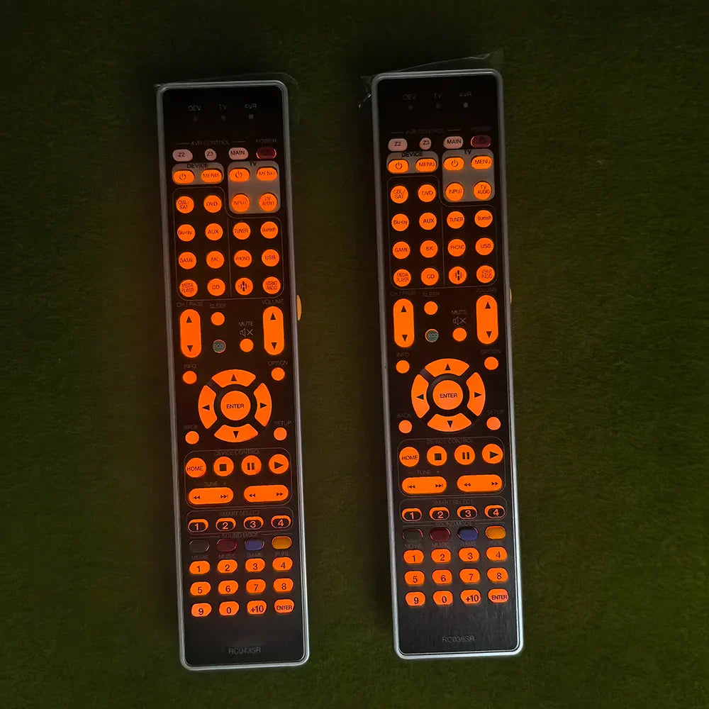 Two black remote controls with glowing orange buttons and silver edges control rc036sr rc043sr compatible with marantz sr7013 sr7012 sr7015