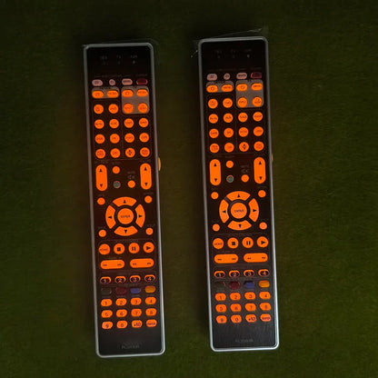 Two black remote controls with glowing orange buttons and silver edges control rc036sr rc043sr compatible with marantz sr7013 sr7012 sr7015