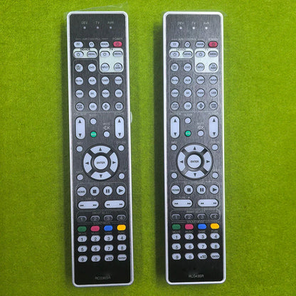 Two silver-toned remote controls with black accents and white buttons control rc036sr rc043sr marantz sr7012 sr7015 compatible