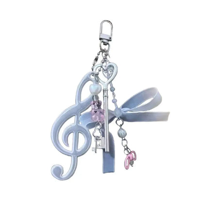 A delicate silver-toned resin music note keychain with pink and white beads and light blue ribbon bow for bags creative bag and phone pendant backpack