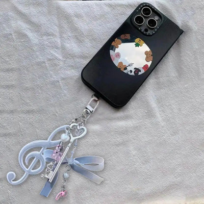 Black phone case with circular mirror featuring cartoon bears and resin music note keychain for bags creative bag charm