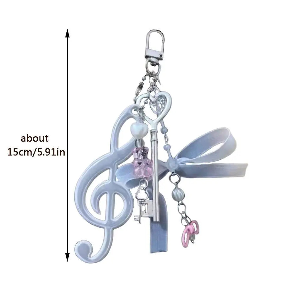 A delicate silver-toned key-shaped charm with heart motif and pink beads for resin music note bags creative bag pendant