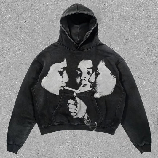Black hoodie with distressed grayscale graphic of two faces sharing a cigarette in hip hop y2k american style sweatshirts