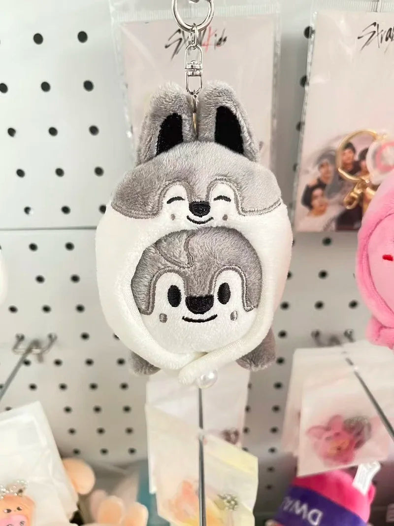 Gray and white skzoo plush keychain with smiling wolf face and black inner ears magic academy cloak toy fan gift