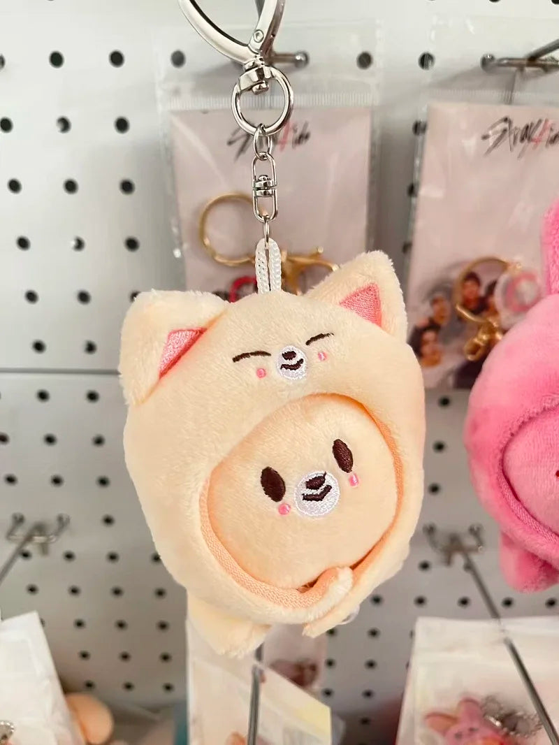 Cream-colored skzoo plush keychain featuring a round-faced character with pink ears and magic academy cloak design toy fan gift