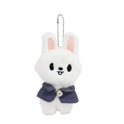 White plush skzoo plush keychain with pink ears wearing navy magic academy cloak and silver bell toy fan gift
