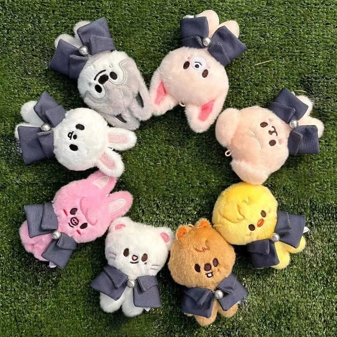 Adorable skzoo plush keychain dolls in pastel tones with navy blue bow and pearl accent for magic academy cloak toy fan gift