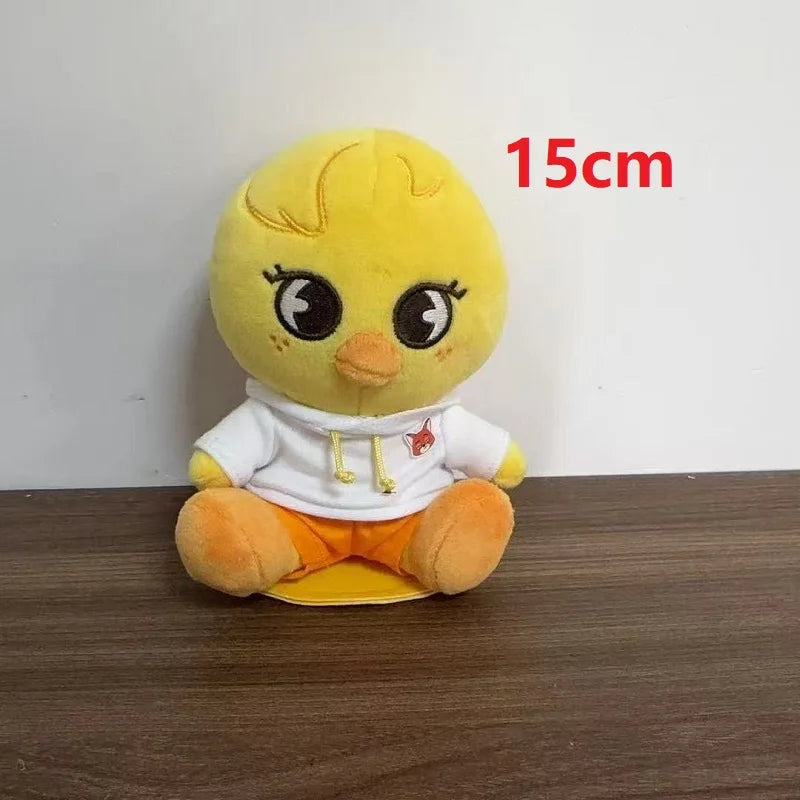 A 15cm yellow plush duck skzoo plush keychain wearing a magic academy cloak style white hoodie and orange shorts toy fan gift