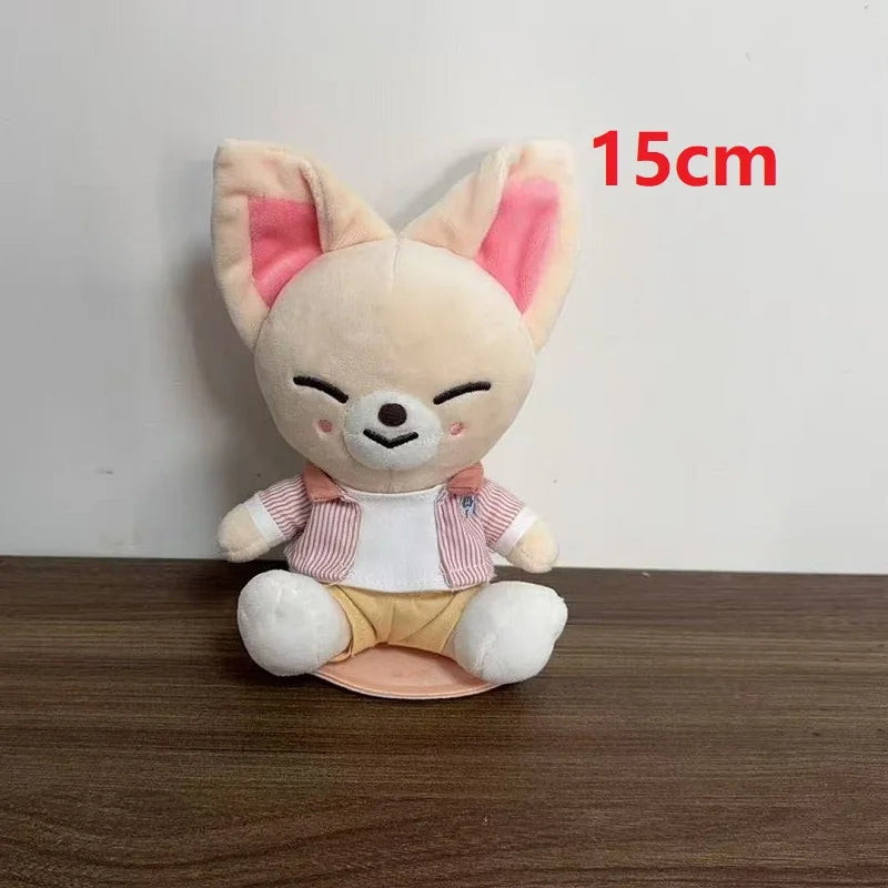 A 15cm skzoo plush keychain toy fan gift featuring a beige fennec fox with a magic academy cloak and colorful outfit