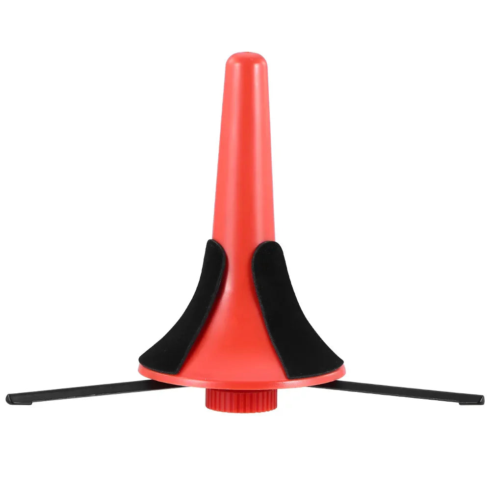 Red plastic trumpet stand portable with foldable metal tripod legs and black rubberized feet for wind instruments