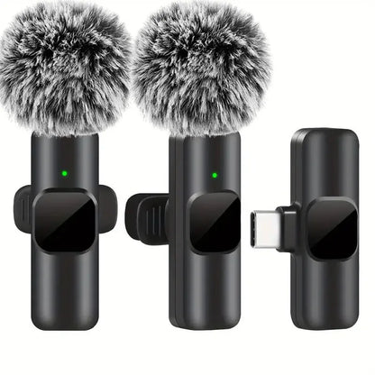 Black wireless lavalier microphone with fuzzy gray windshields and green indicator lights for portable audio video recording mini use