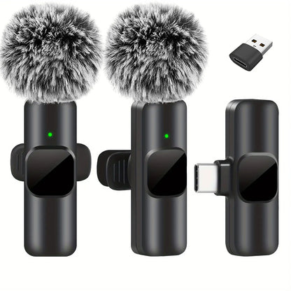 Black wireless lavalier microphone with fuzzy gray windshields and green indicator lights for portable audio video recording mini use