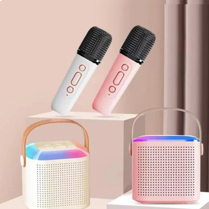 Two wireless microphone karaoke devices in white and pink with black mesh grille and control buttons for mp3 player karaoke