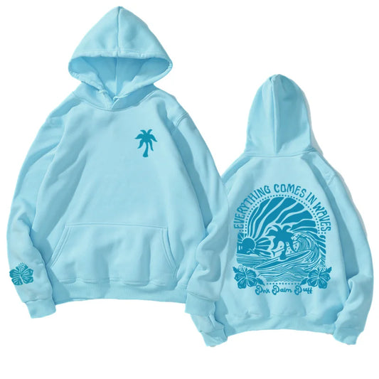 Light blue youth tropical flower hoodie with palm tree graphic front and surf design back featuring everything comes in waves
