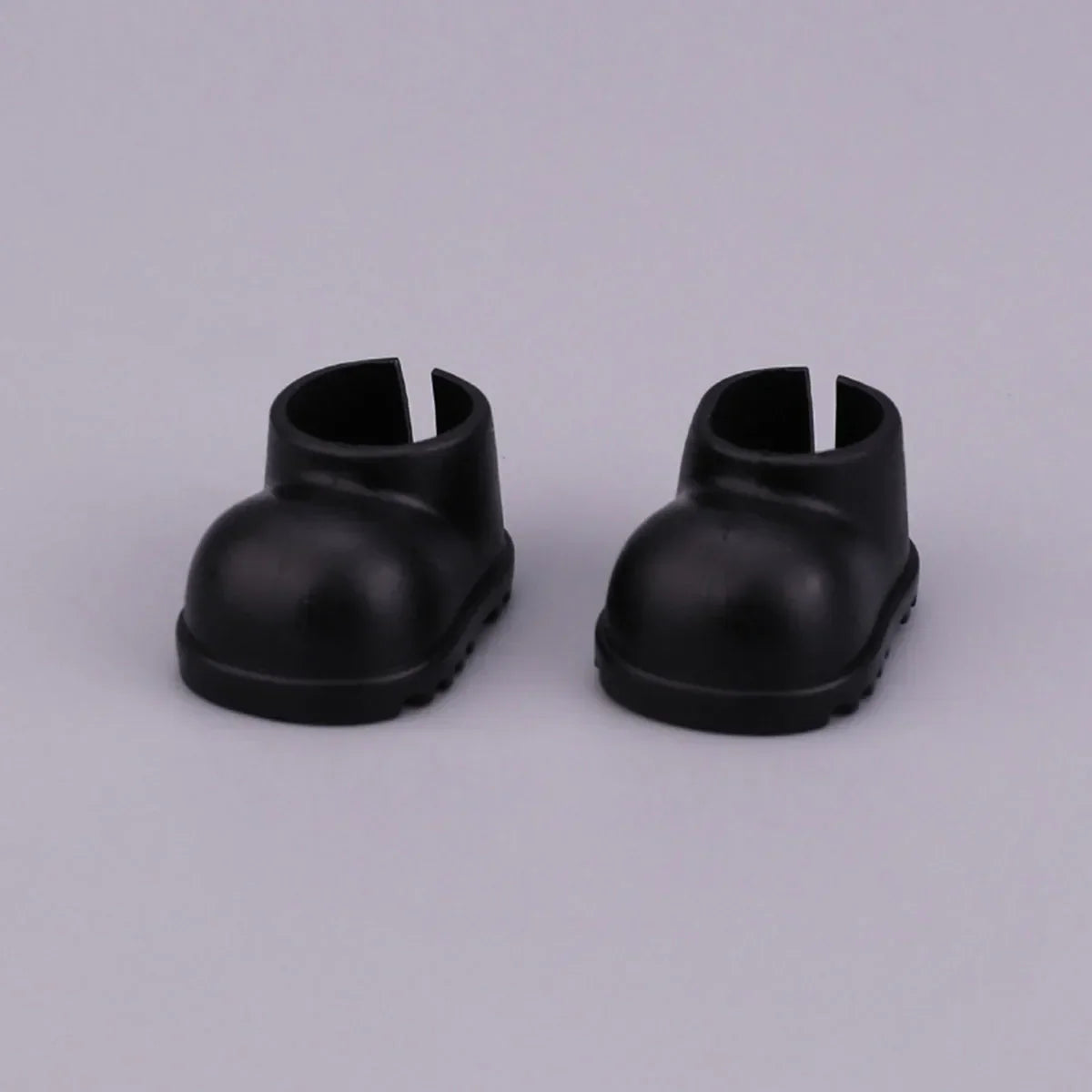 A pair of black plastic doll boots with rounded toe and open back for labubu clothes gifts black suit fashion