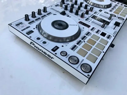 White pioneer ddj-sr dj controller with black knobs and silver accents fully surrounded by protective stickers from beat music store