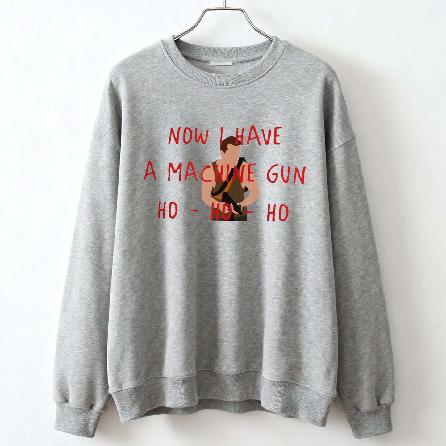 Gray crewneck sweatshirt with red and brown graphic print featuring die hard mclane naktomi plaza design and text