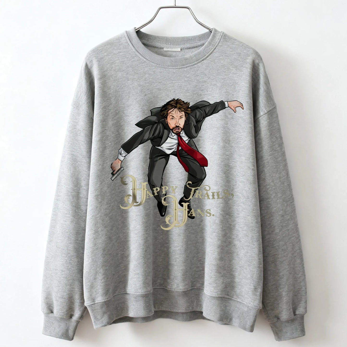 Gray unisex sweatshirt with cartoon die hard mclane illustration and happy trails hans text for casual wear