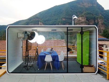 Modern transparent glass office pod soundproof with white frame and vibrant green panel for outdoor meeting living pods