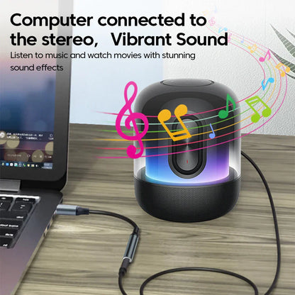 Black cylindrical speaker with translucent front glowing led lights connected to laptop via headset microphone usb audio jack adapter external stereo sound card